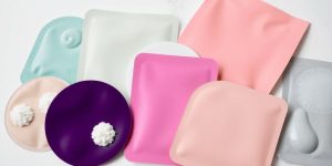 Colorful skincare patches on a clean background.