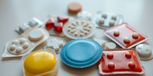 Assorted pain relief patches on a clean surface.